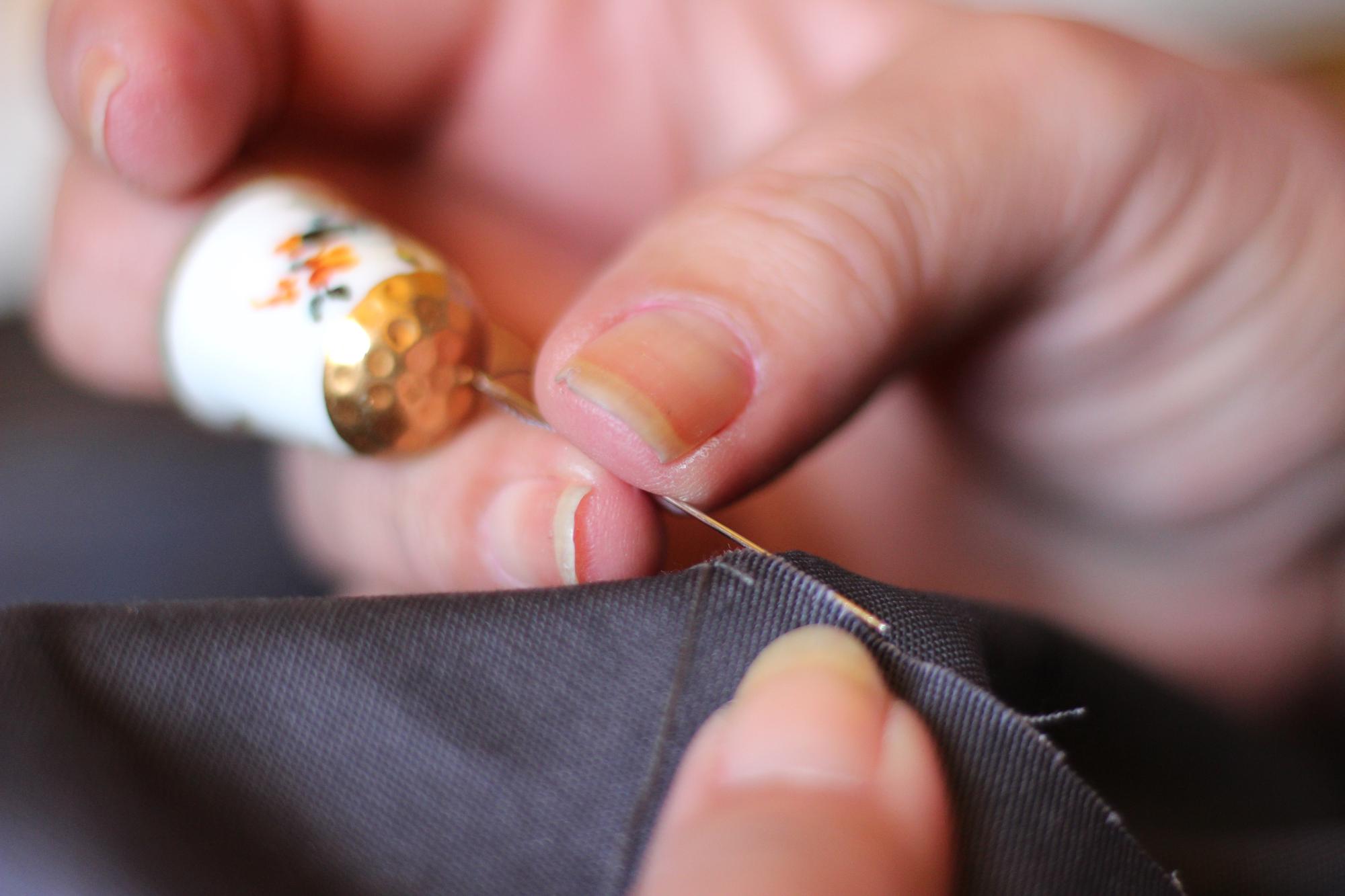 Close-up of hand embroidery with metallic threads on silk